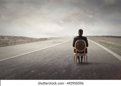 Sitting On A Chair In A Solitary Road