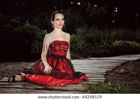 Similar – Melancholic girl with red dress in nature