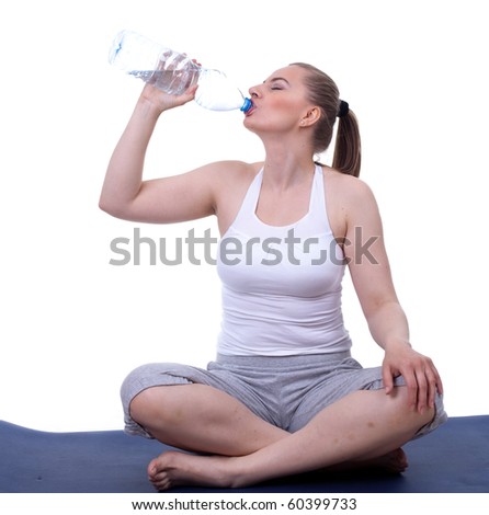 sitting on floor on blue mat resting woman drinking water
