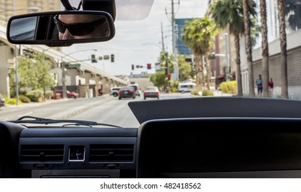 Sitting On The Passenger Seat Inside A Taxi Cab During The Day.