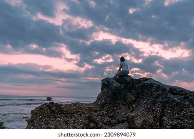 Sitting on a rock while looking at the horizon and the ocean releases the saturation on a hot summer afternoon