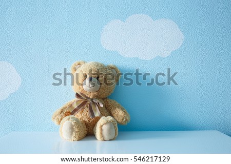 Sitting toy bear on the background of Wallpapers of clouds and sky