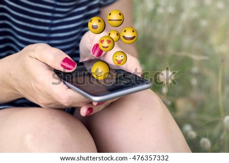 Similar – Nahaufnahme der Frau mit dem Smartphone, die Emojis sendet.