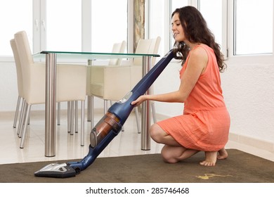 Sitting Woman With A Vacuum Cleaner