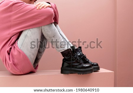 Sitting woman wearing combat boots