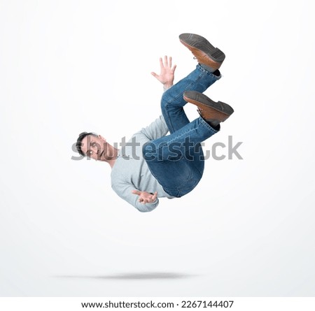 Situation, the man in casual clothes is falling down on light background. Concept of an accident