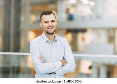  The Situation In The Office At Work. Business Portrait Of A Young Successful Man.