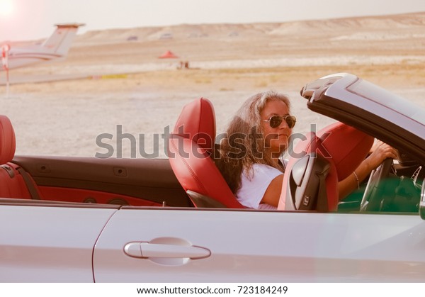 Sivrihisar, Eskisehir, Turkey -\
September 17, 2017: Sivrihisar Airshows (SHG), small aviation event\
displayed in SUSHM. Cool car driver on her way to the check\
point.