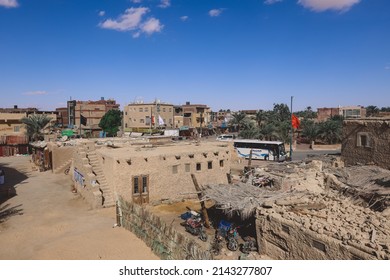 Siwa, Egypt - November 03, 2021: Cityscape View With Old Cars, Local People And Buildings In The Siwa Oasis Between The Qattara Depression And The Great Sand Sea In The Western Desert