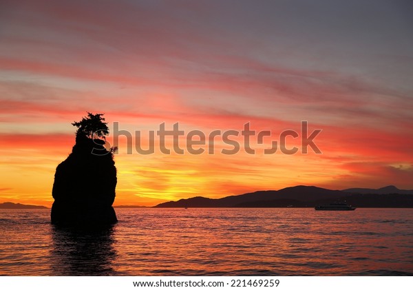  Siwash Rock Sunset, English Bay,\
Vancouver. Sunset over English Bay silhouetting Siwash Rock in\
Stanley Park. Vancouver, British Columbia, Canada.\
