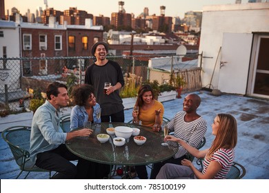 Six Adult Friends Enjoying A Party On A New York Rooftop