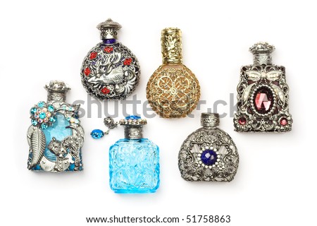 Six antique perfume glass richly ornate bottles, isolated on white.
