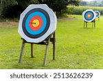 Six arows on archery target sticking in center middle on archery shooting range 1