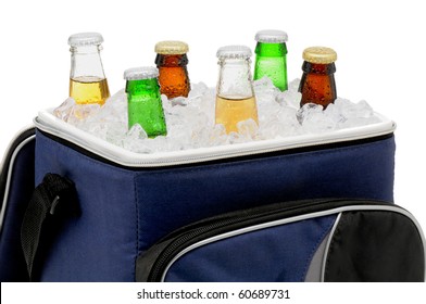 Six Assorted Beer Bottles In A Soft Sided Cooler Or Ice Chest. Close Up In Horizontal Format Isolated Over White.