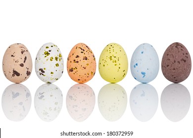 Six candy coated chocolate Easter eggs in a line, isolated on white with clipping path. - Powered by Shutterstock