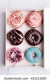 six color donuts in a white box