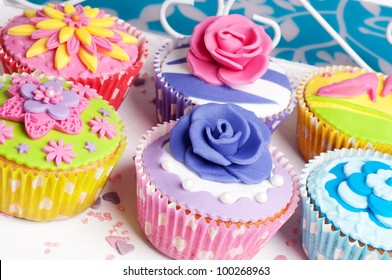 Six Colorful Spring Cupcakes With Floral Decoration