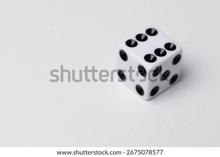 Six dots on cube dice perspective view on studio background