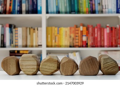 Six Empty Wooden Blocks In Front Of Home Library. Blank Wood Blocks Mockup And Blurred Bookshelf.