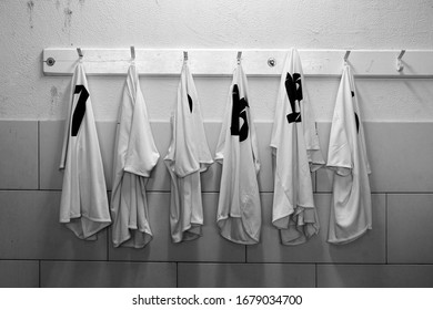 Six Football Shirts Hanging On Dressing Room Before After The Game - Black And White