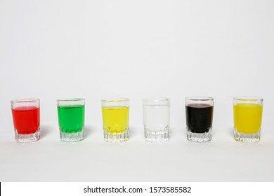 Six Glasses With Colorful Water Content Lined Up 