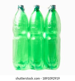 Six Green Plastic Bottles In Plastic Pack Isolated On White Background