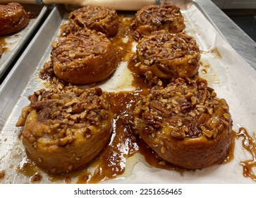 Six homemade cinnamon sticky buns straight from the oven - Shutterstock ID 2251656465