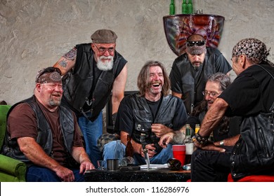 Six Male Biker Gang Members Laughing With Weapons On Table