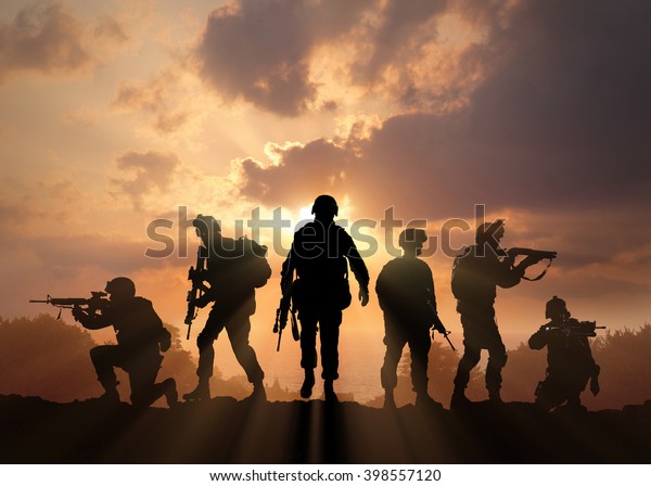 Six\
military silhouettes on sunset sky\
background