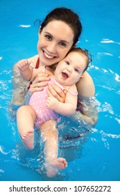 Six Month  Baby Girl At His First Swimming Lesson With Mother