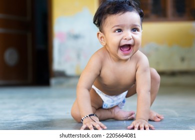 Six Months Infant Child Boy Naked Only Wear Diaper Sitting On Floor Laughing Out Loud