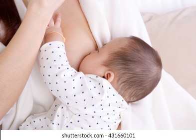 Six Months Old Baby Boy Drinking Breastmilk