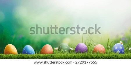 Six painted easter eggs celebrating a Happy Easter on a spring day with a green grass meadow, bright sunlight and a cool colour background with copy space.