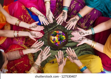 Six Pairs Of Henna Decorated Female Hands Arranged In A Circle On A Colorful Background.