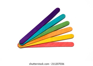 Six Popsicle Craft Sticks Of Different Colors Are Fanned Out Over White.