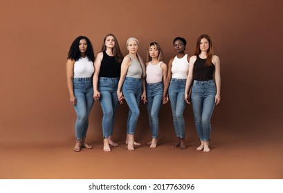 Six Serious Women Standing Together Holding Hands In Studio