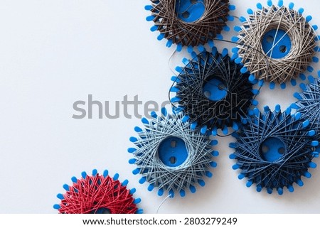 six spools of sewing thread and darning thread in different designs and colors
