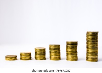 Six stacks of coin in ascending order on white gray background. Photo illustration of success in business and commerce, growth of revenue, investment, wage,  rising prices for goods, services - Powered by Shutterstock