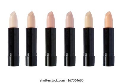 Six tones of concealer sticks isolated over white