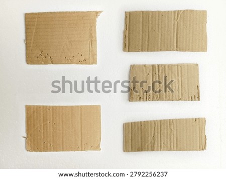 Six torn rectangular cardboard pieces with visible corrugation and worn edges arranged on a clean white background, suitable for packaging, craft projects, texture references, recycled material concepts, and design mockups.
