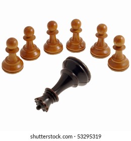 Six White Chess Pawns Standing In A Semi Circle Around A Lying Black Queen Against A White Background