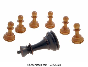 Six White Chess Pawns Standing In A Semi Circle Around A Lying Black King Against A White Background