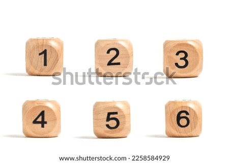Six wooden cubes with numbers for board games white background