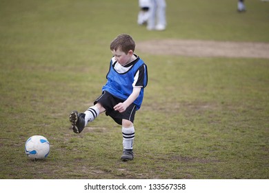 Six Year Old Boy Playing Soccer On A Saturday Morning