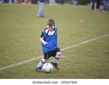 Six Year Old Boy Playing Soccer On A Saturday Morning