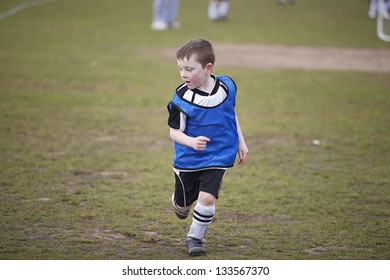 Six Year Old Boy Playing Soccer On A Saturday Morning