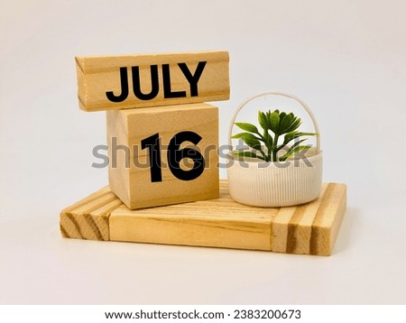 Sixteenth july written over wooden blocks 