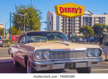  Sixties Era Parked Chevrolet With Bright Denny's Sign In Back. Emeryville Ca. Circa 2017