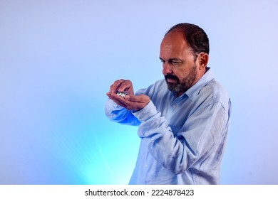 Sixty Year Old Man Holding Medicine In Hand