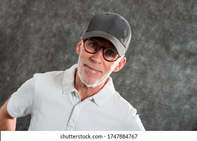 A Sixty Year Old Man Wearing A Baseball Cap